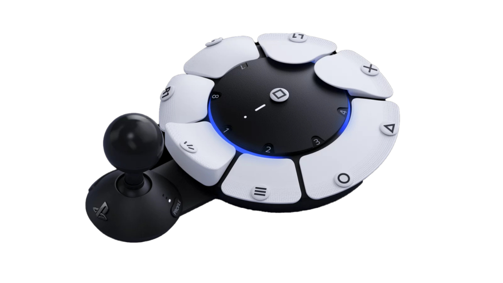 PlayStation Access Controller, a video game controller designed to help people with disabilities play video games more easily. The controller is a circular panel that features several buttons around the circumference. Attached is a large joystick on the left side.